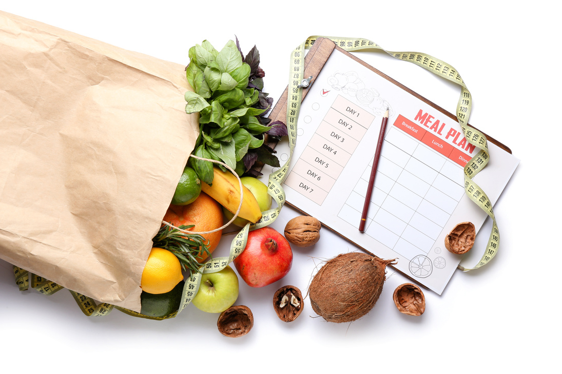 Paper Bag with Healthy Products, Measuring Tape and Meal Plan on White Background